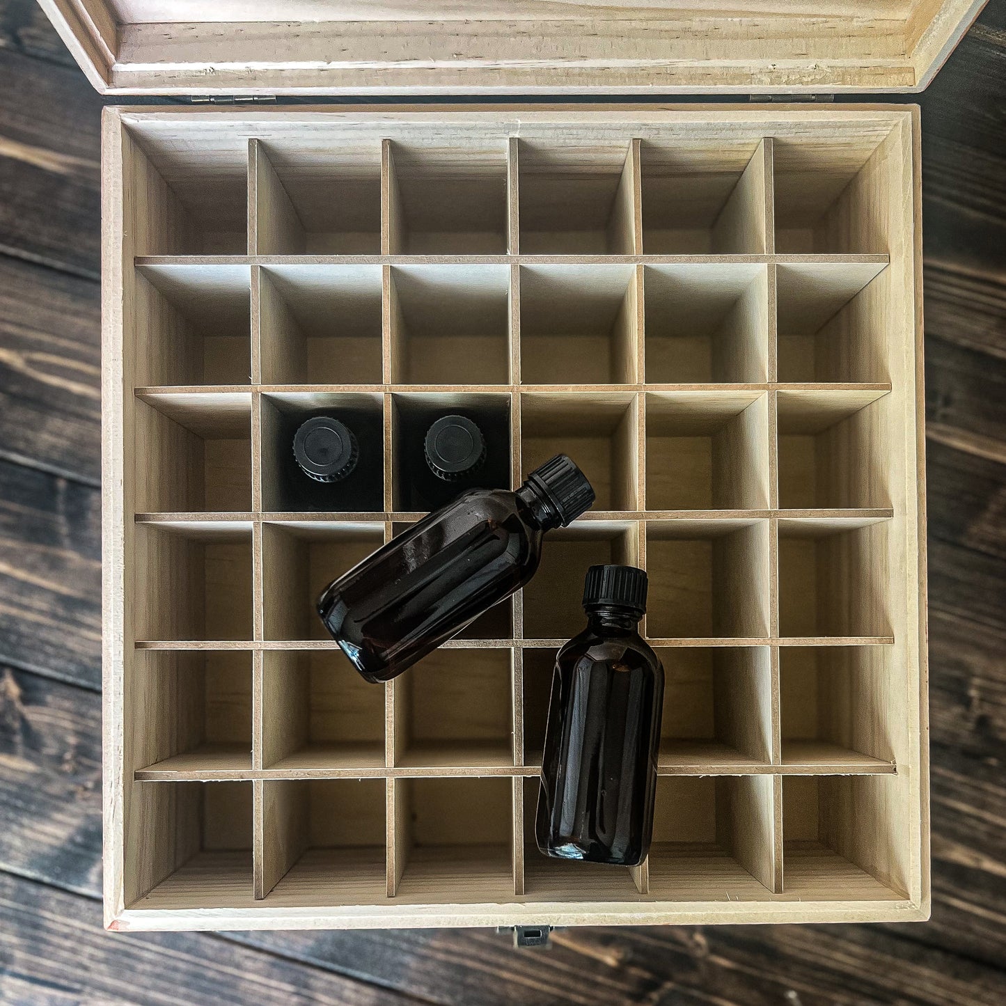 2 oz Whiskey Sample Bottle Decorative Storage box, open showing 36 slots, 4 empty sample bottles are laying in and around the box