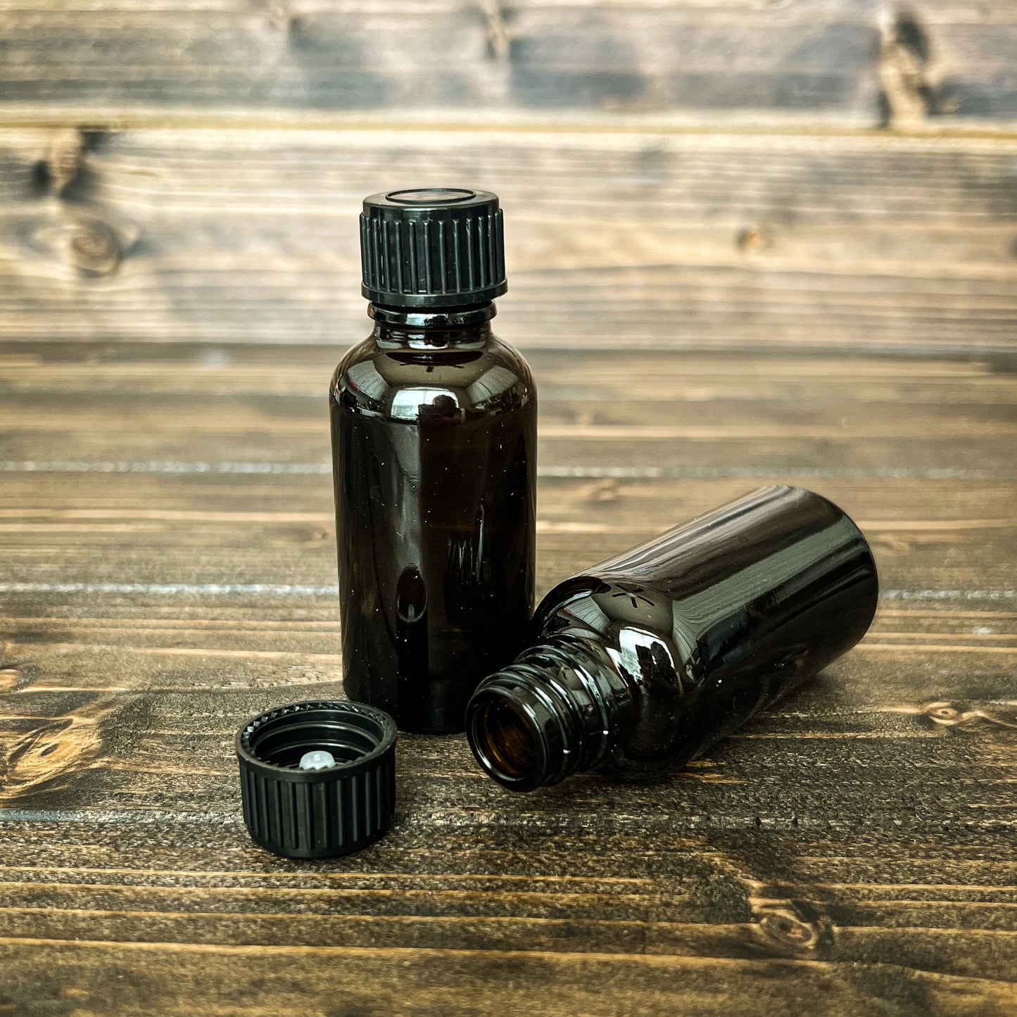 photo of 2 one ounces amber glass bottles with polycone lids