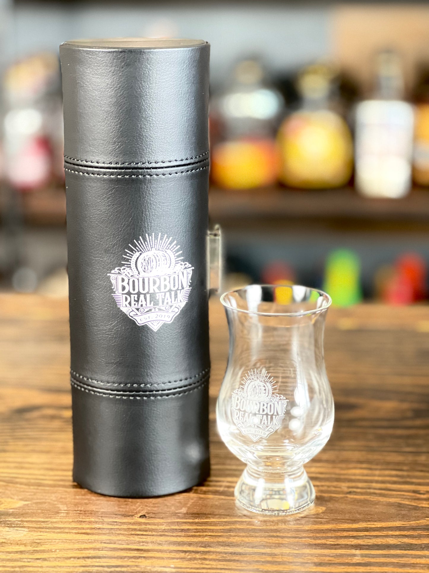 Bourbon Real Talk™ 6oz Tasting Glass Carrier WITH GLASSES, closed case with one glass on table next to the case