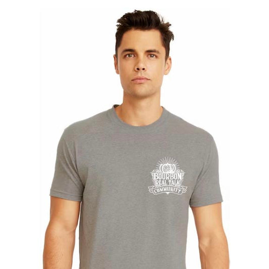 Man in gray shirt with the Bourbon Real Talk Community logo on the chest pocket area 