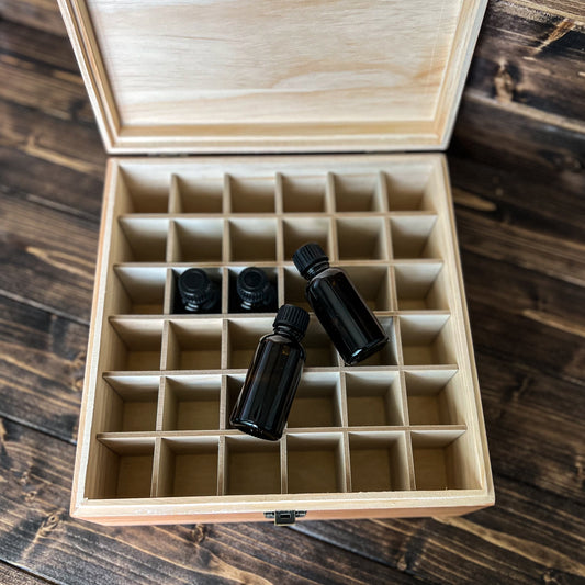 1 oz Whiskey Sample Bottle Decorative Storage box, open box with 36 spaces for 1oz samples bottles. 4 glass sample bottles are shown.
