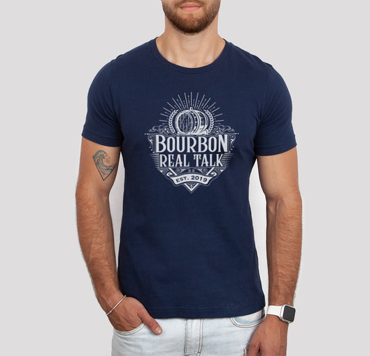 Man wearing a navy Bourbon Real Talk tshirt and jeans